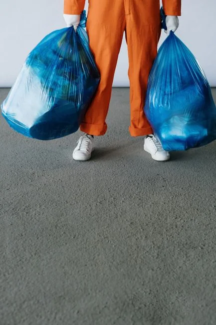 Latex gloves and spray detergent placed on table in stylish living room in daytime